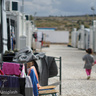 Syrian refugees walking on street during daytime