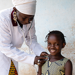 Pediatrician examines a girl during routine respiratory check-up