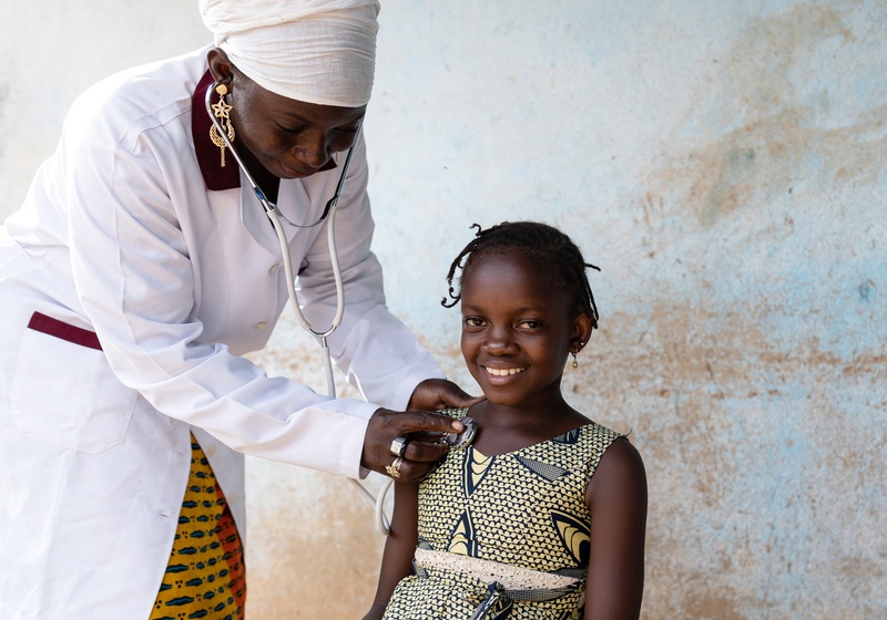 Young girl is examined by a healthcare professional