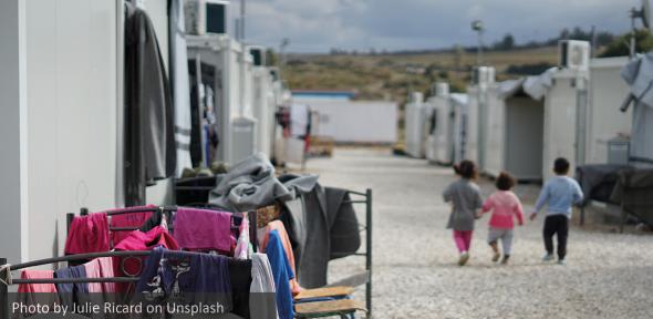 Syrian refugees walking on street during daytime Syrian refugees walking on street during daytime